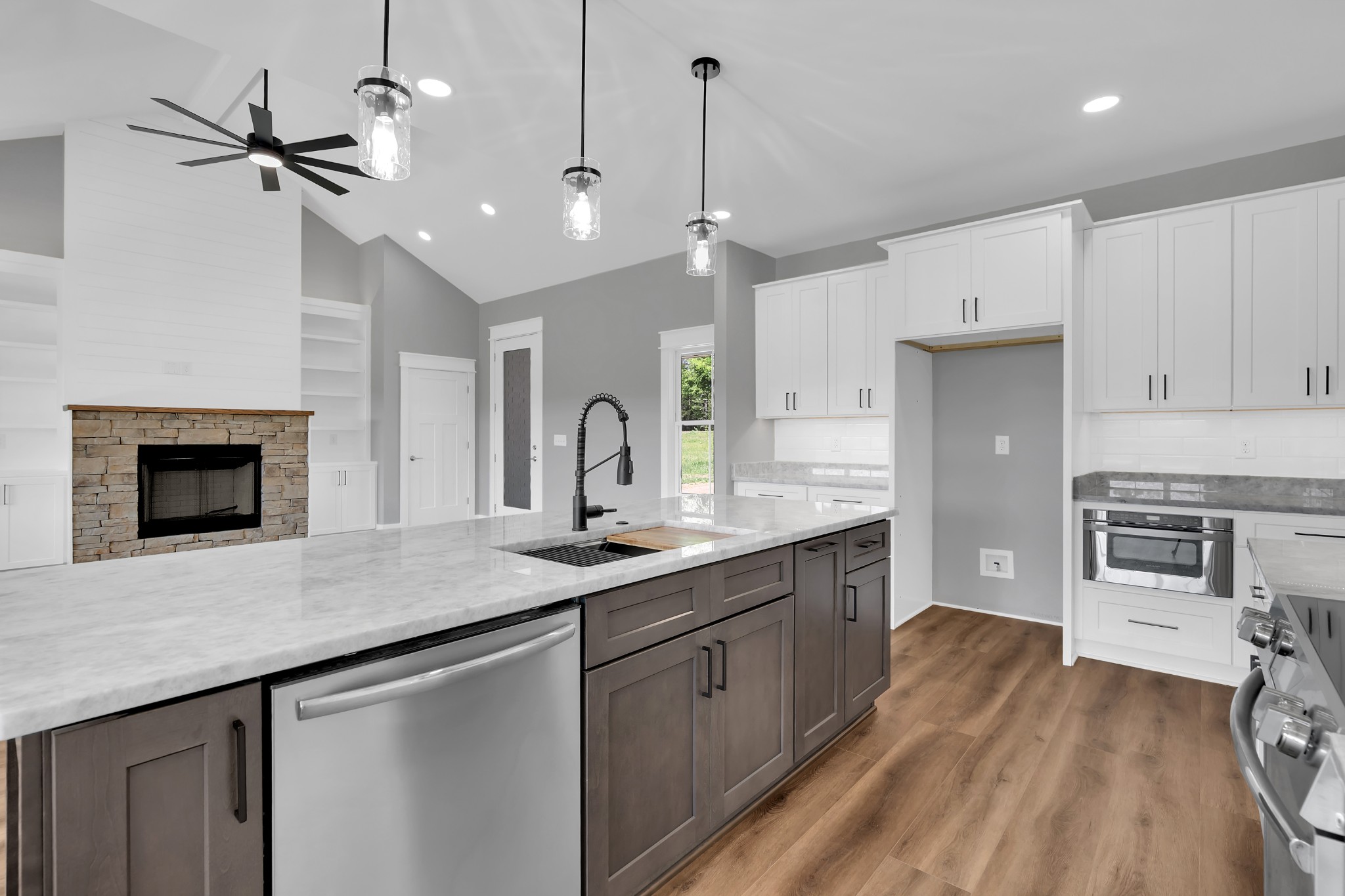 8246 Aedc Road Estill Springs, TN 37330 - Photo 17 of 55 a kitchen with stainless steel appliances granite countertop a sink a stove and a wooden floors