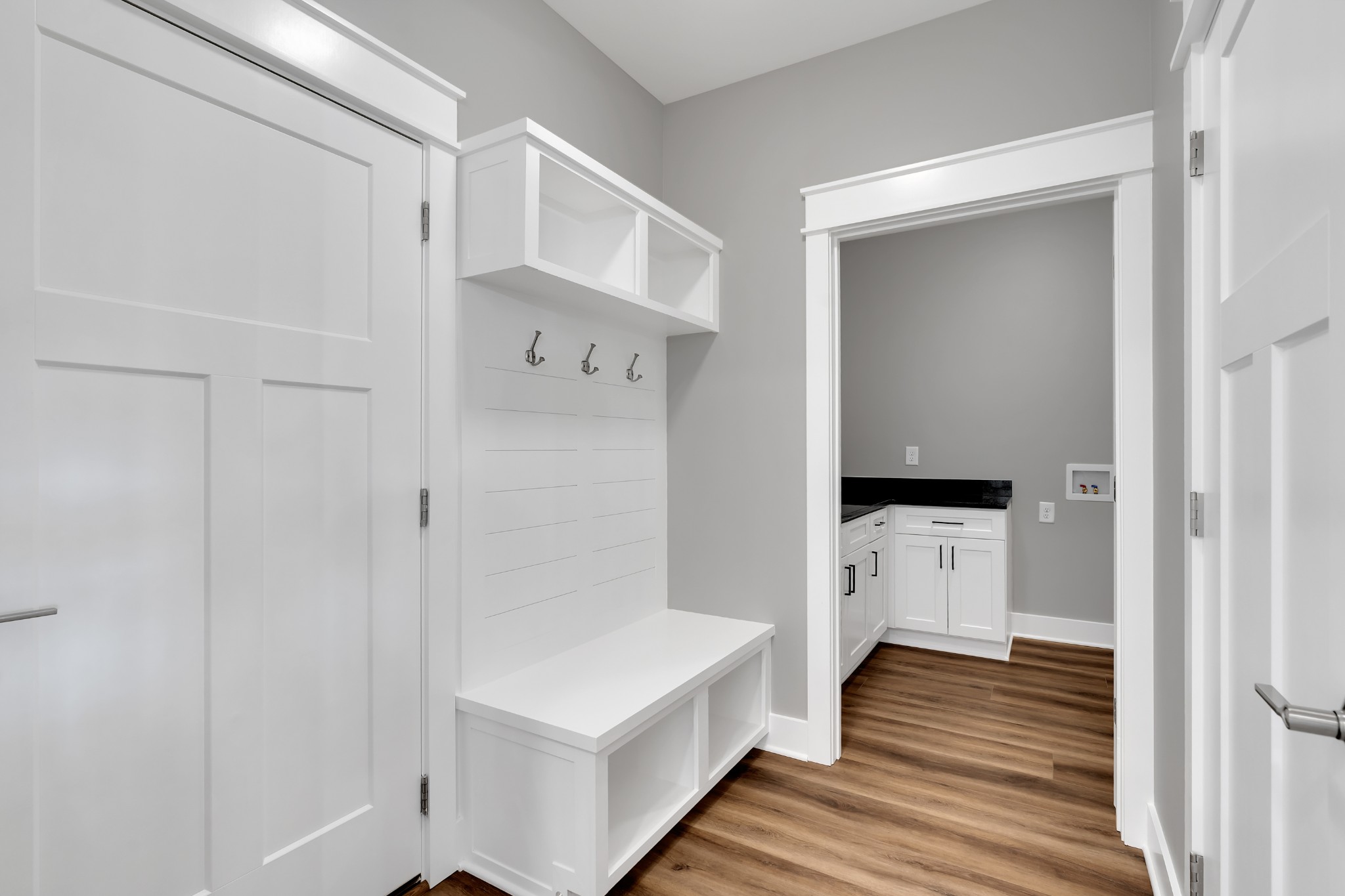 8246 Aedc Road Estill Springs, TN 37330 - Photo 23 of 55 a hallway with white cabinets and wooden floor