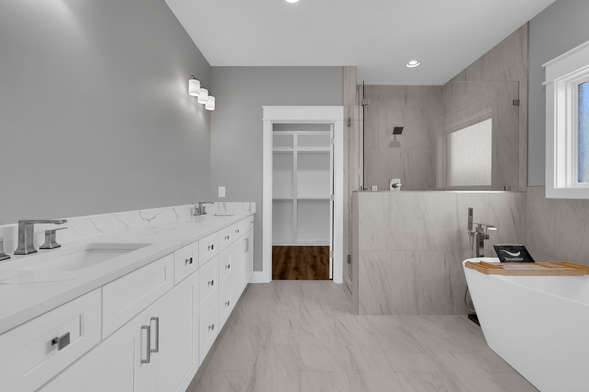 8246 Aedc Road Estill Springs, TN 37330 - Photo 31 of 55 a bathroom with a double vanity sink a mirror and a bathtub