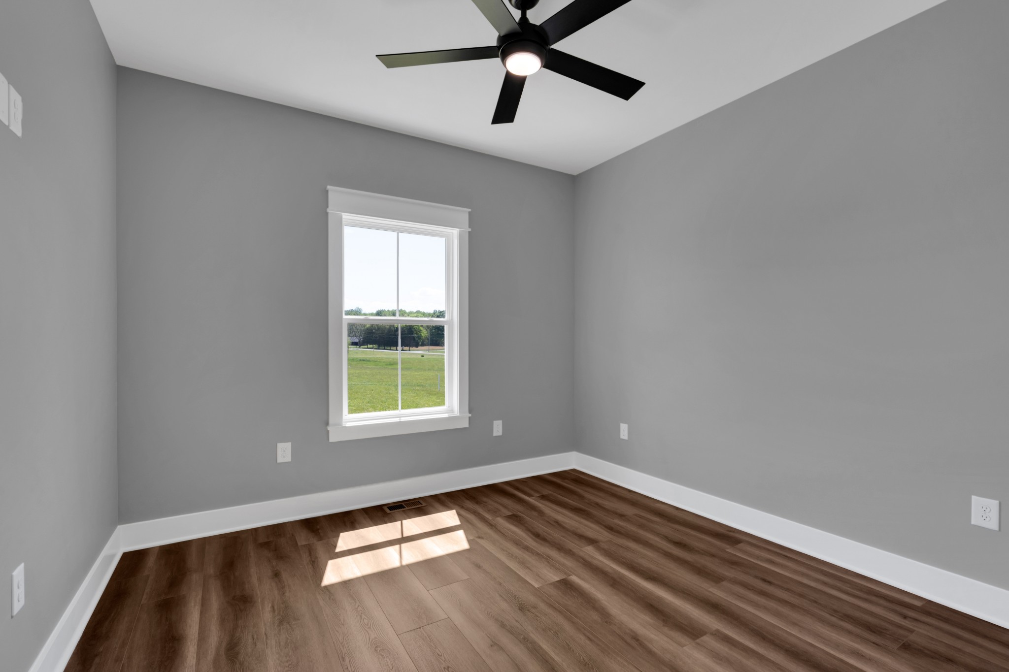 8246 Aedc Road Estill Springs, TN 37330 - Photo 38 of 55 a view of empty room with wooden floor and fan