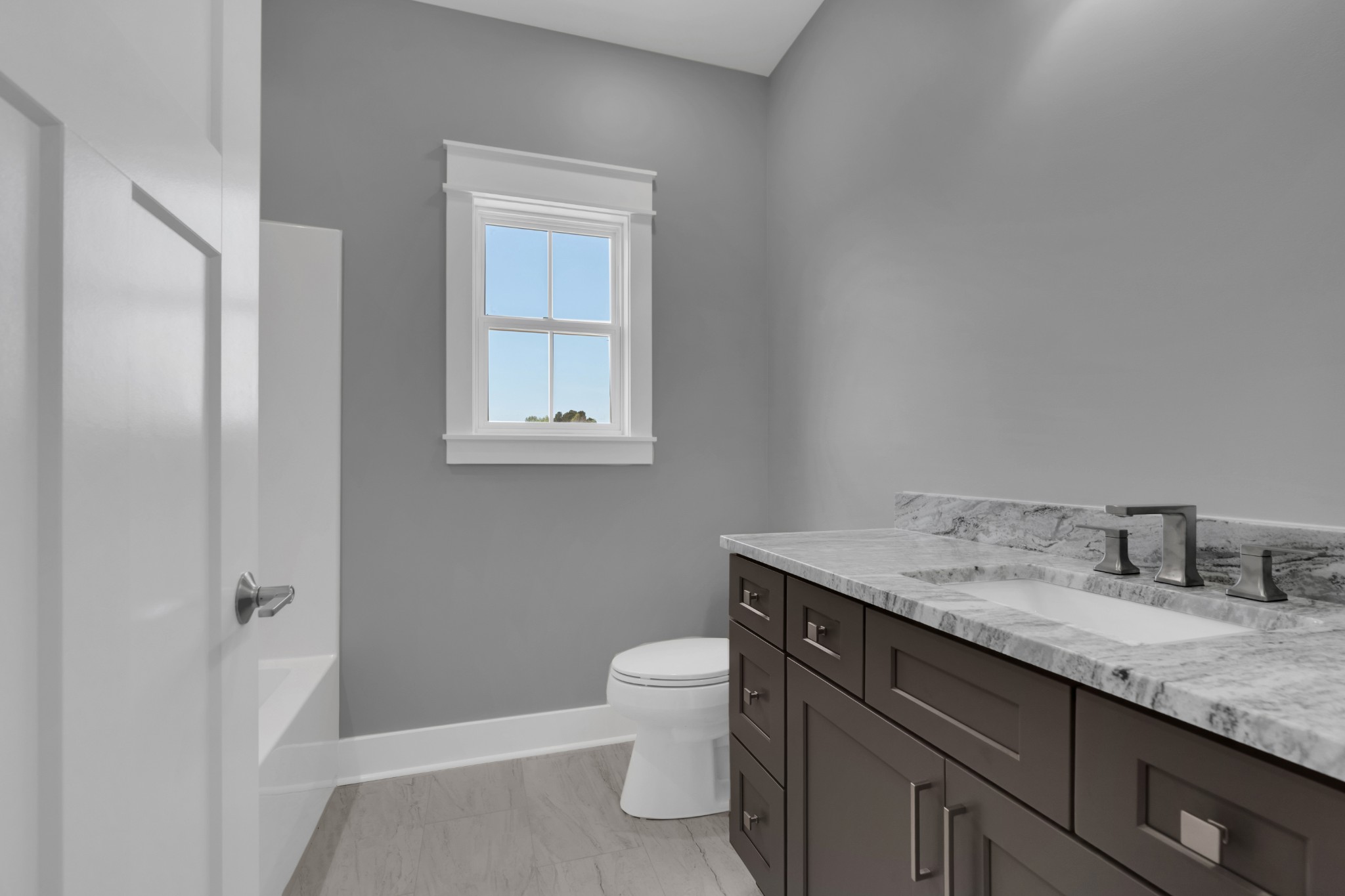 8246 Aedc Road Estill Springs, TN 37330 - Photo 40 of 55 a bathroom with a granite countertop sink a toilet and a mirror