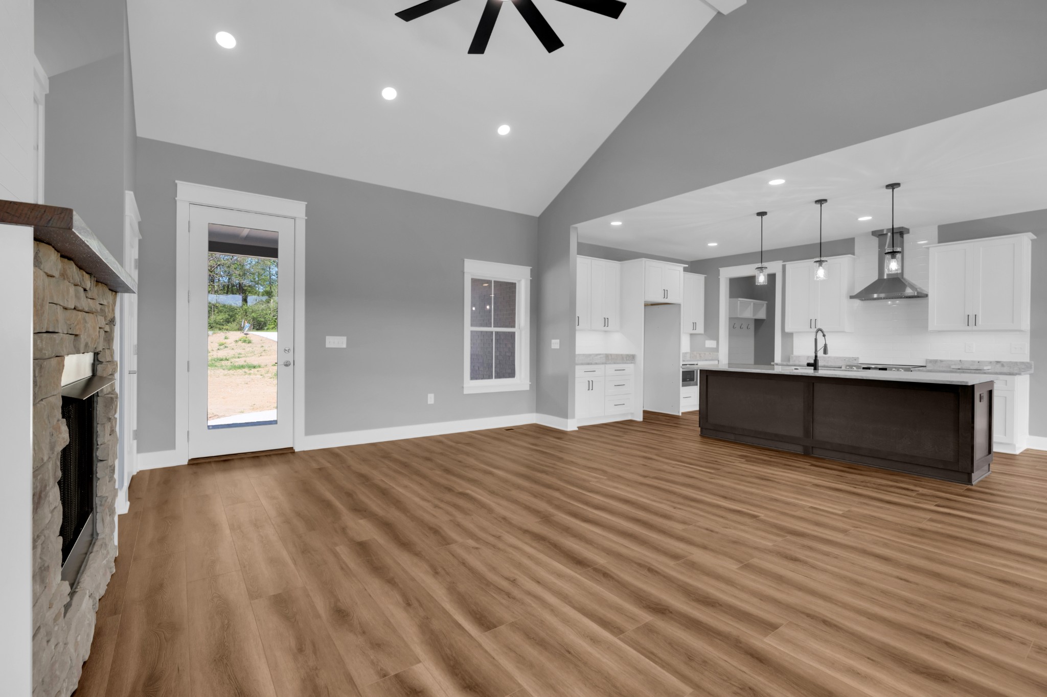 8246 Aedc Road Estill Springs, TN 37330 - Photo 10 of 55 a view of kitchen and hall with wooden floor and a fireplace