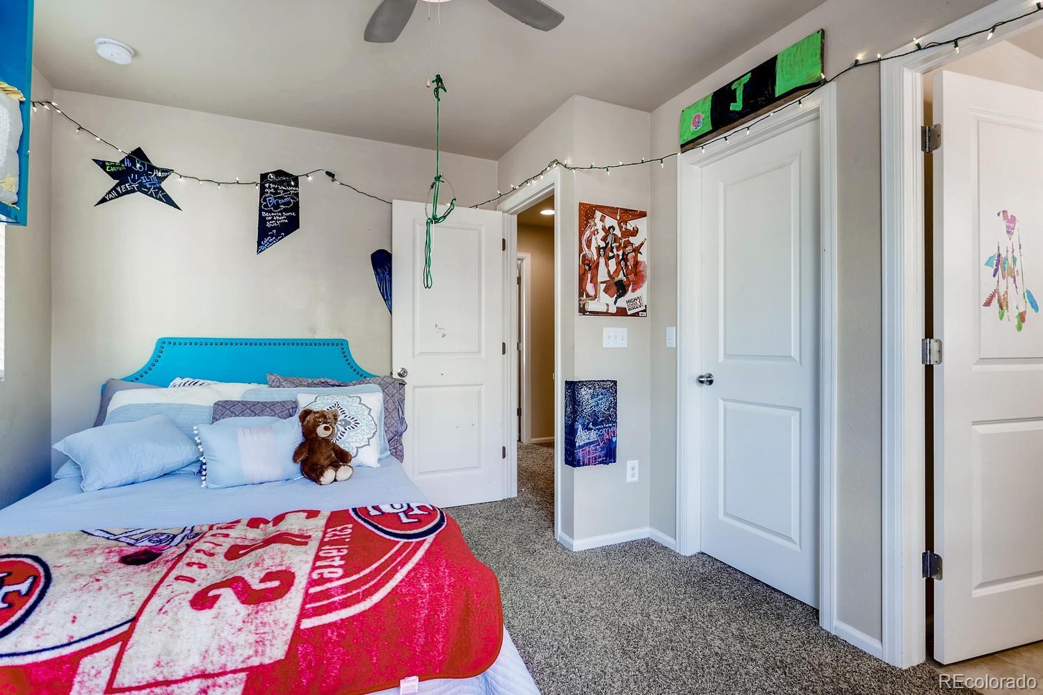 9520 Halstead Lane Lone Tree, CO 80124 - Photo 12 of 20 a bedroom with furniture and a chandelier