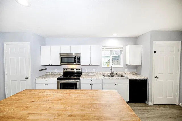 a kitchen with a sink stove and cabinets