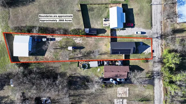 a view of a white house with a yard and fence