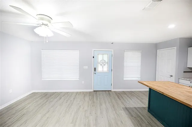 a large kitchen with cabinets and stainless steel appliances