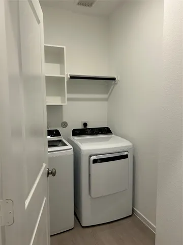 a view of storage and utility room with washer and dryer