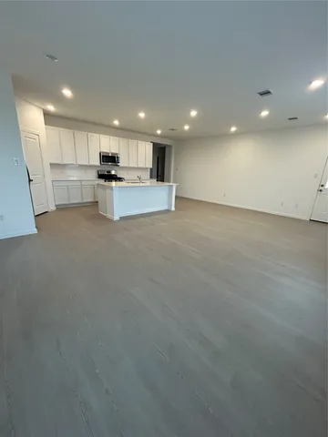a view of kitchen with refrigerator and window