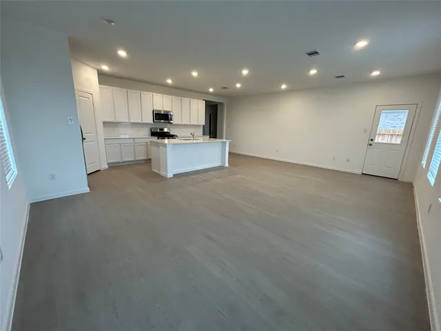 a view of kitchen with kitchen island sink and center island