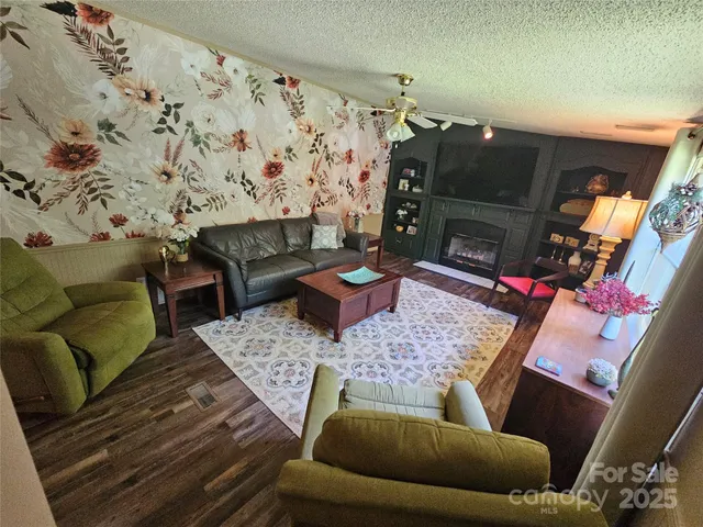 a living room with furniture and a fireplace