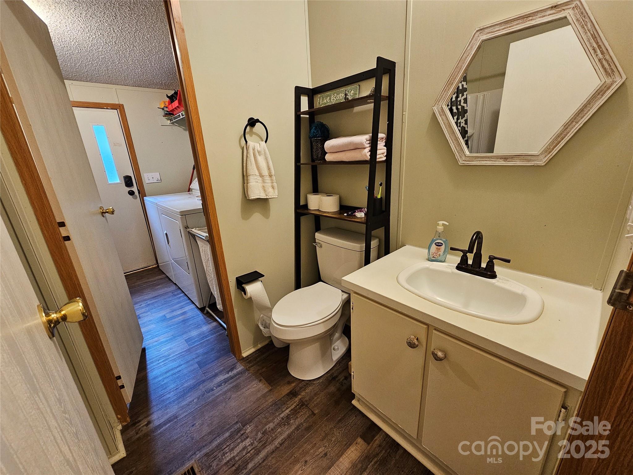 5062 Taylor Farm Road Lenoir, NC 28645 - Photo 16 of 25 a bathroom with a sink a toilet and mirror