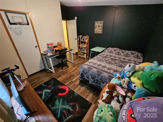 a bedroom with bed and a mirror