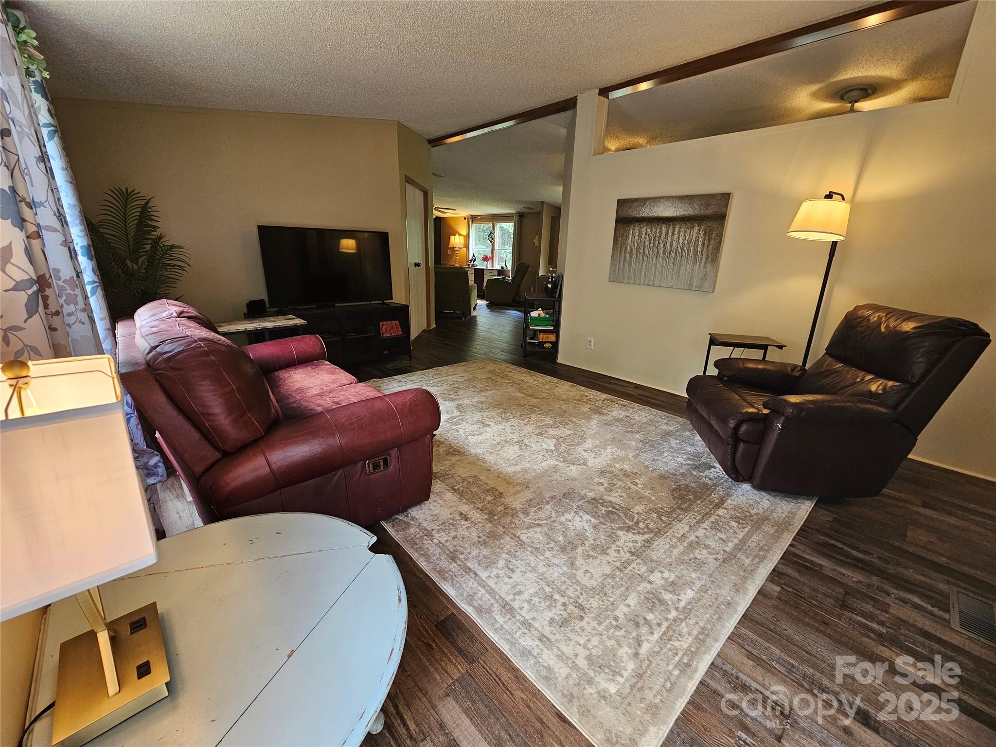 5062 Taylor Farm Road Lenoir, NC 28645 - Photo 3 of 25 a living room with furniture and a flat screen tv