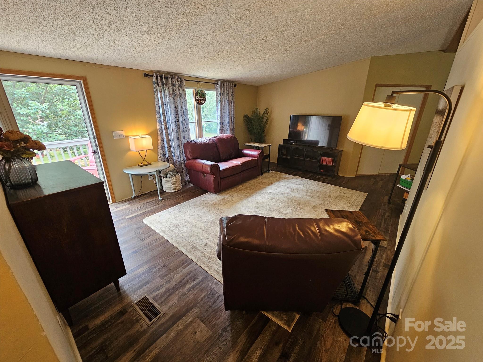 5062 Taylor Farm Road Lenoir, NC 28645 - Photo 4 of 25 a living room with furniture and a fireplace