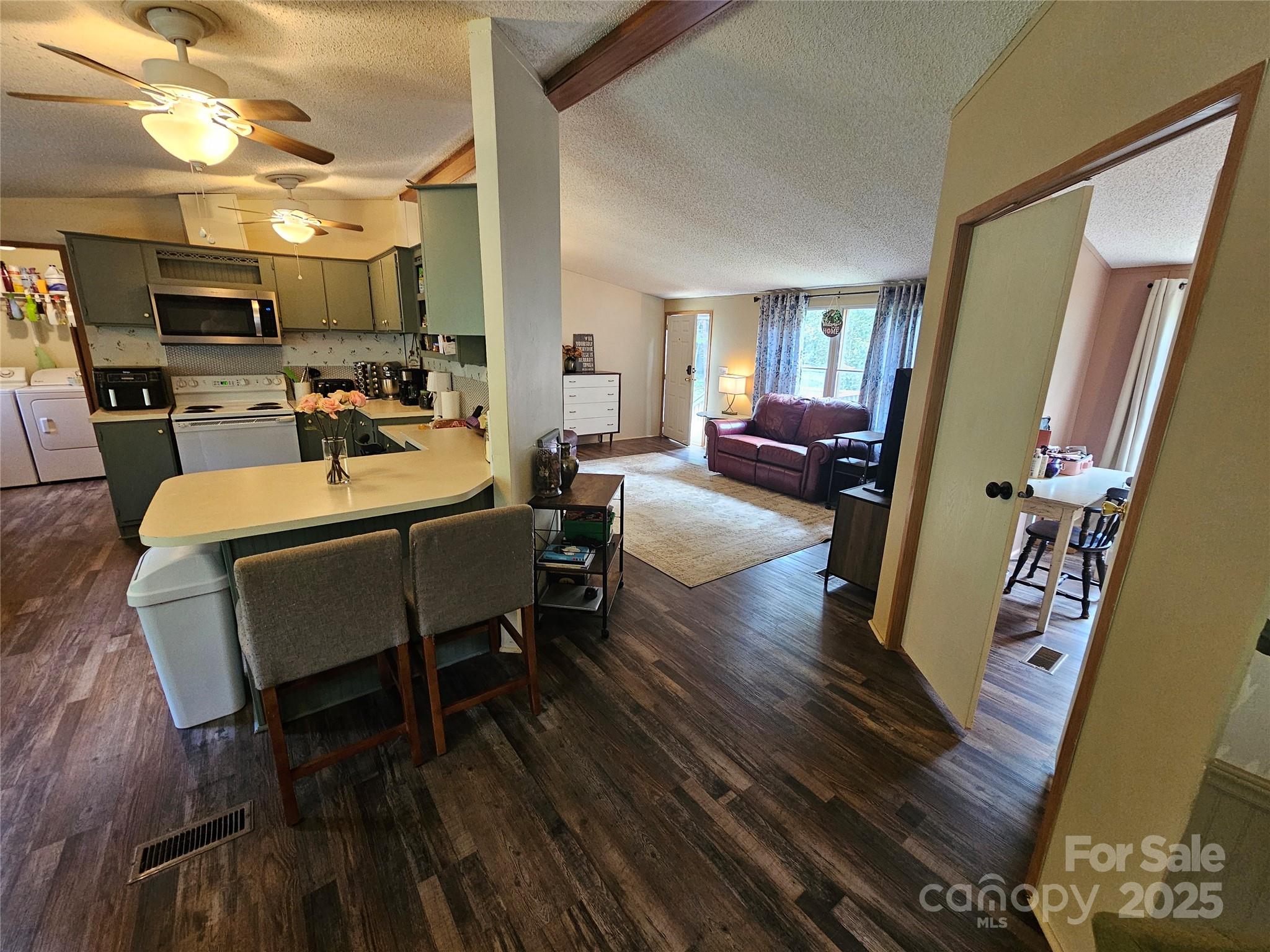 5062 Taylor Farm Road Lenoir, NC 28645 - Photo 6 of 25 a view of a dining room with furniture window and wooden floor