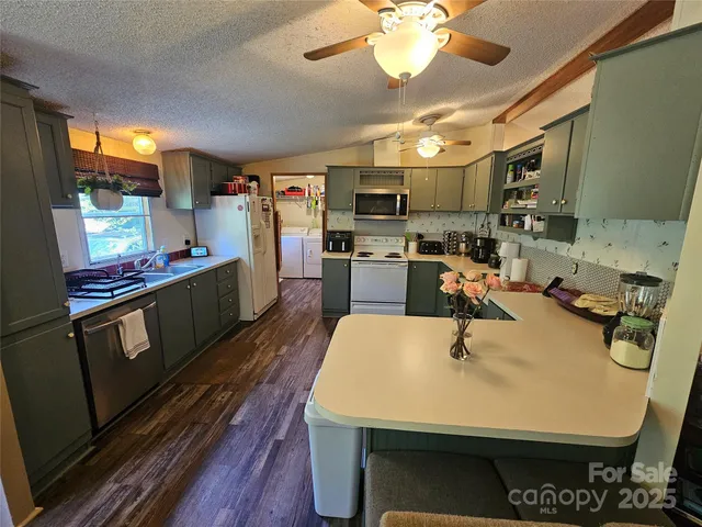 a large kitchen with a table chairs and a refrigerator