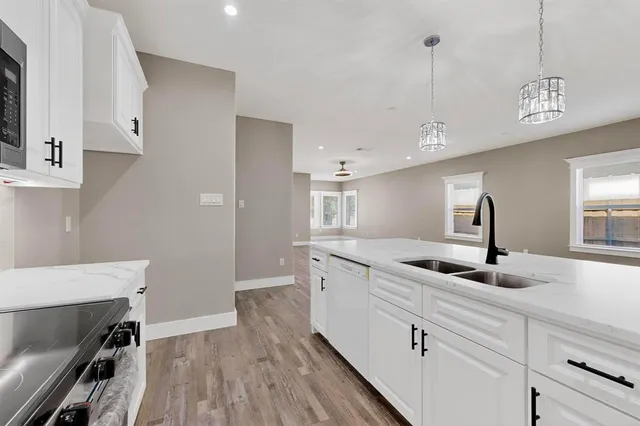 a kitchen with a sink a counter space and cabinets