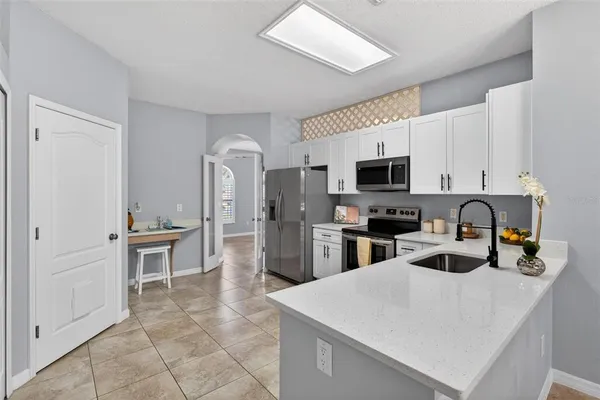 a kitchen with sink cabinets and stainless steel appliances