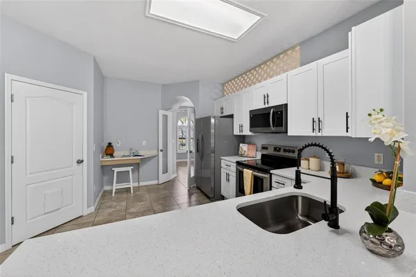 a kitchen with a sink cabinets and appliances