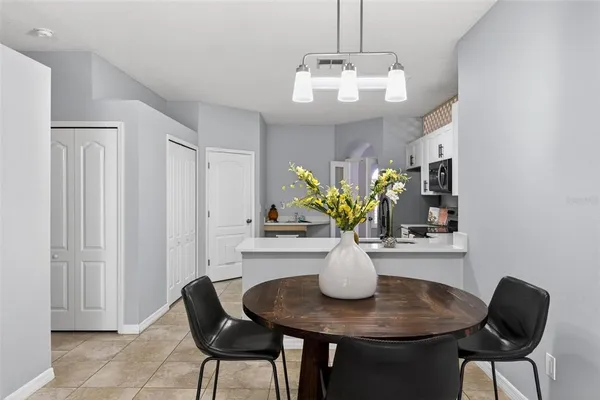 a view of a dining room with furniture and a chandelier
