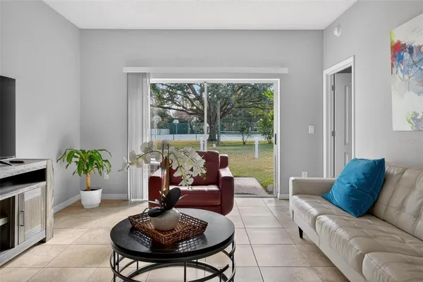 a living room with furniture and a potted plant