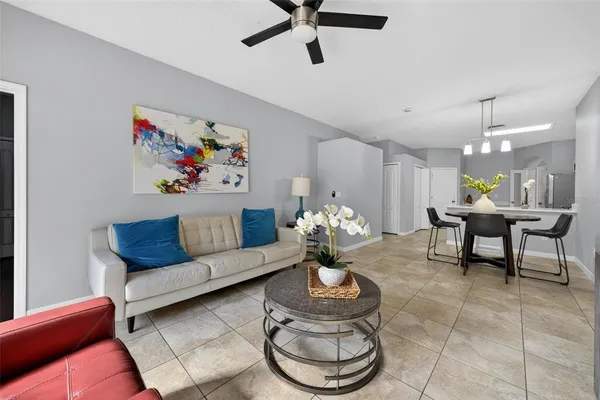 a living room with furniture and a chandelier