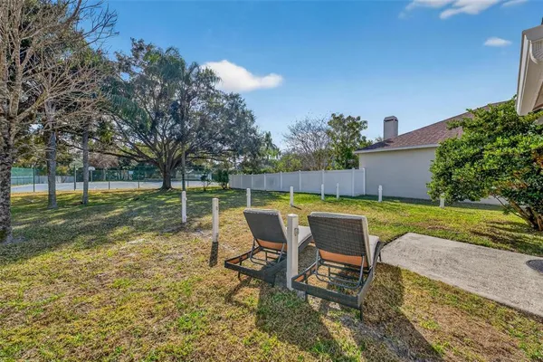 a view of a backyard with swimming pool