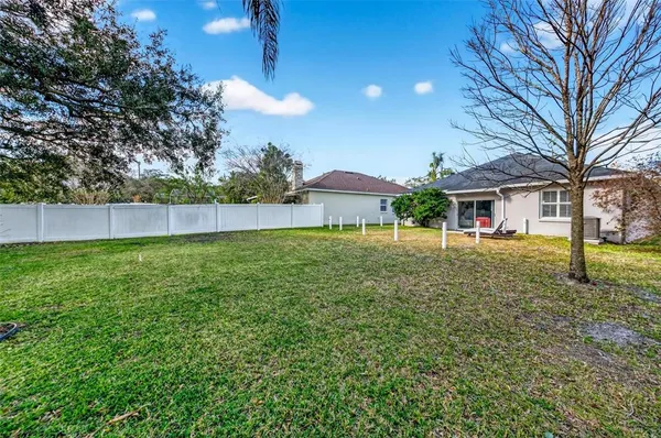 a view of house with a yard