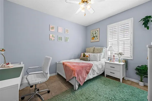 a bedroom with a bed and a chair