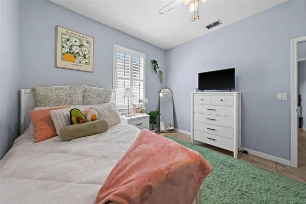 a bedroom with a bed and a television