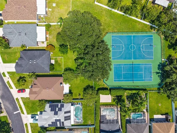 an aerial view of a house with garden space and street view