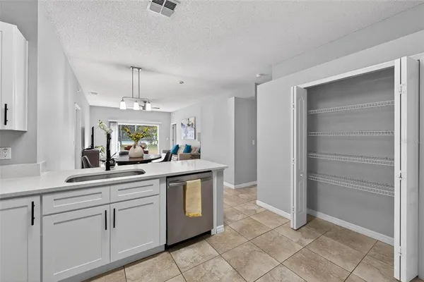 a kitchen with stainless steel appliances granite countertop a sink and cabinets