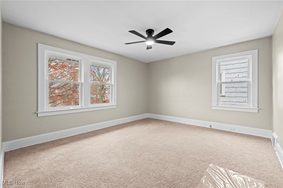 1056 Quilliams Road Cleveland, OH 44121 - Photo 15 of 37 Spare room with light colored carpet and ceiling fan