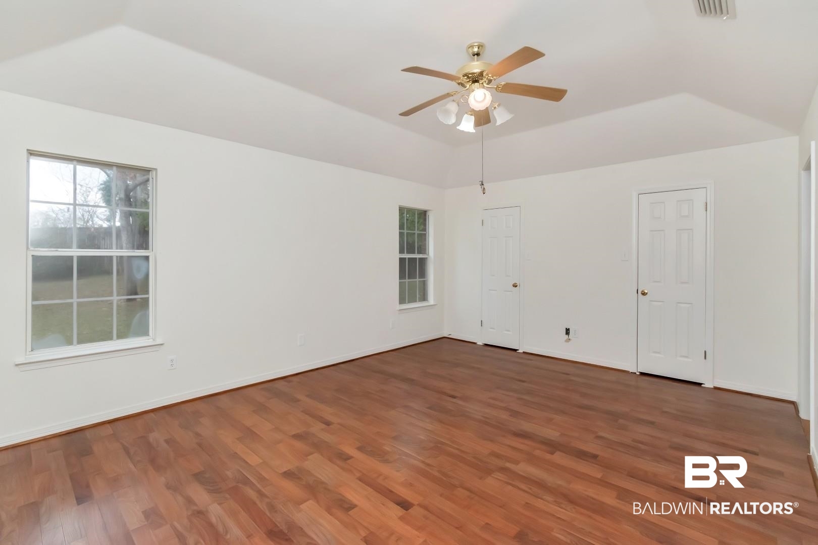 10006 Wedgefield Court Mobile, AL 36608 - Photo 34 of 34 Unfurnished room with a ceiling fan, dark wood-style flooring, vaulted ceiling, and baseboards