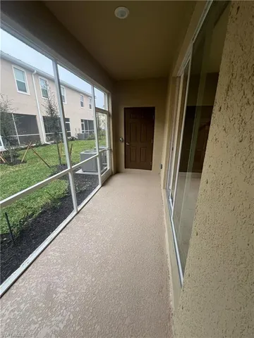 a view of porch with a floor to ceiling window and wooden fence