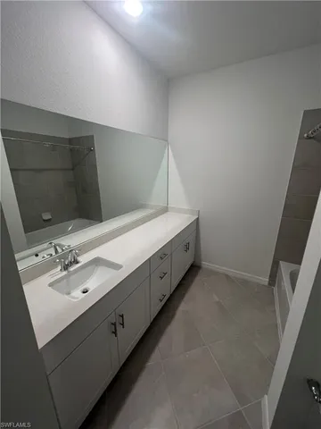 a bathroom with a double vanity sink and mirror