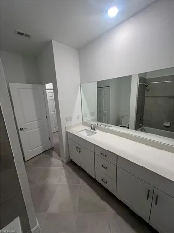 a bathroom with a double vanity sink and mirror