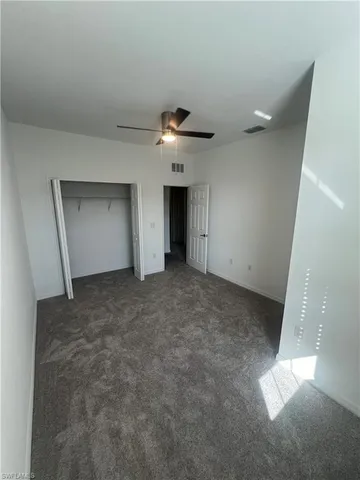 a view of an empty room with a ceiling fan