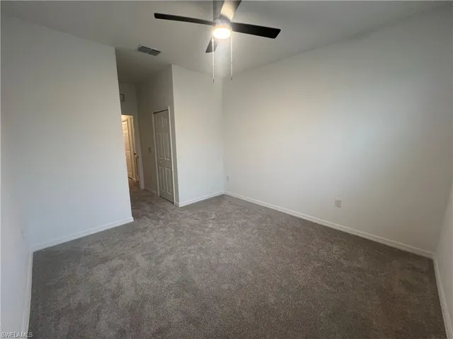 an empty room with a empty space and a ceiling fan