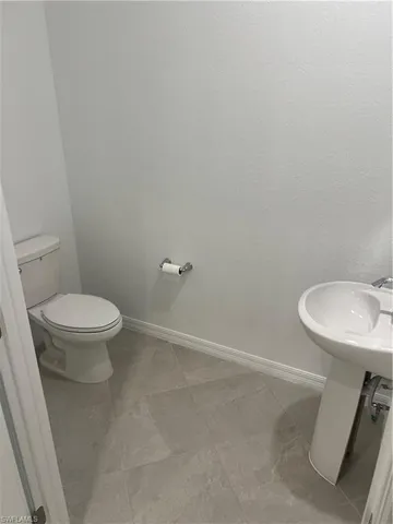 a white toilet sitting next to a sink