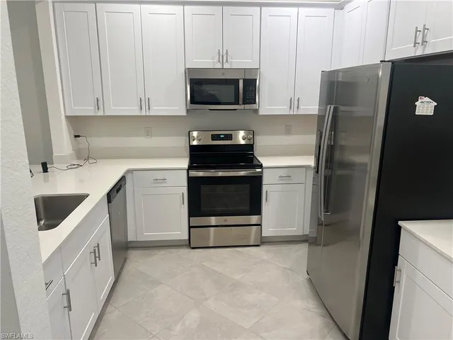 a kitchen with a refrigerator stove and microwave