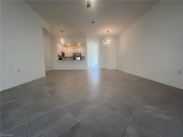 a view of an empty room and a window