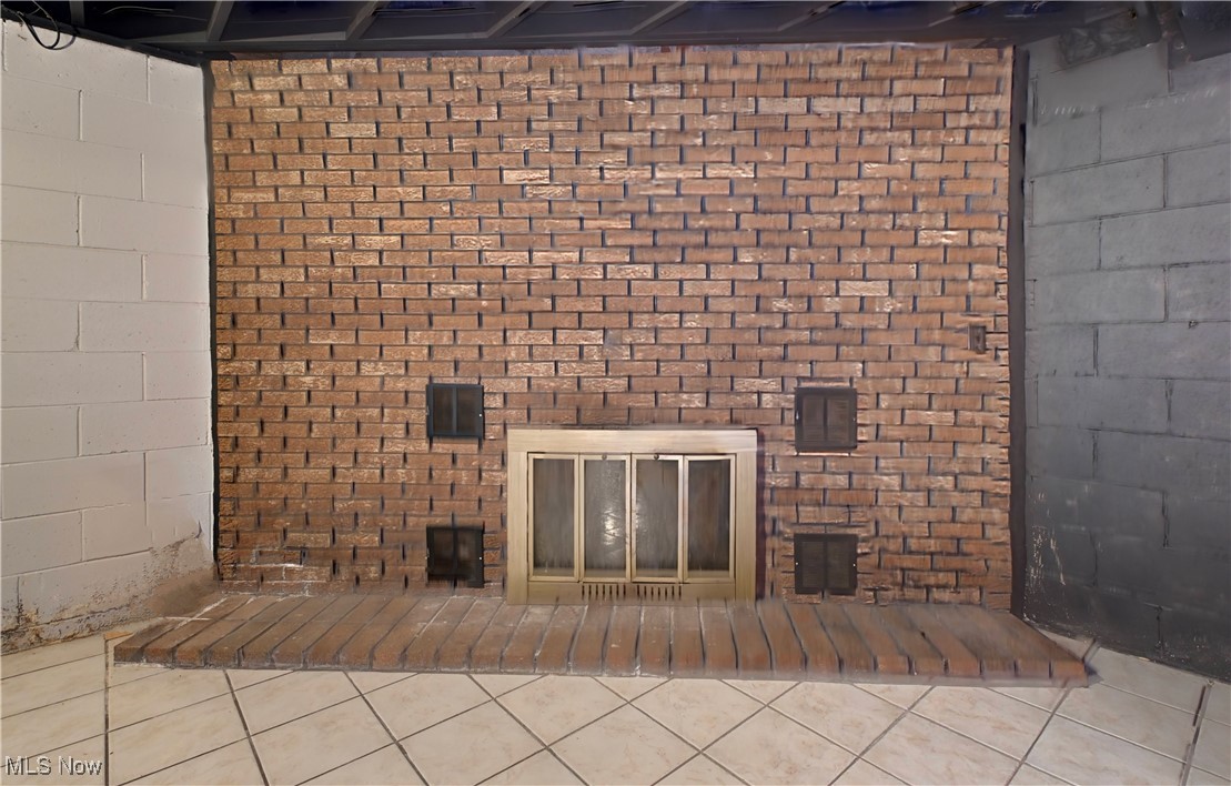 5747 Middle Run Road Dover, OH 44622 - Photo 23 of 30 Unfurnished living room with concrete block wall and tile patterned flooring
