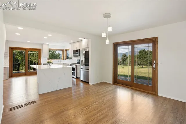 a view of a kitchen with a sink and a large window