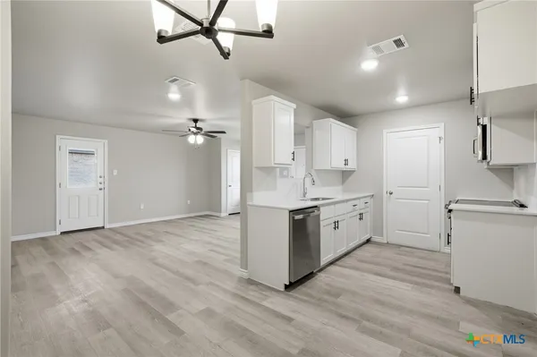 a view of a kitchen with electric appliances
