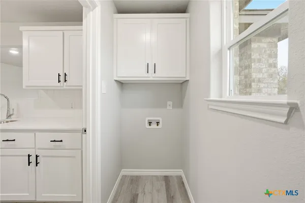 a bathroom with a sink and mirror with window