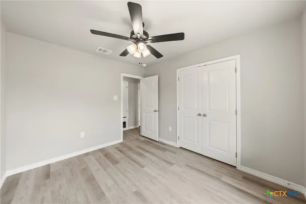 a view of an empty room and wooden floor