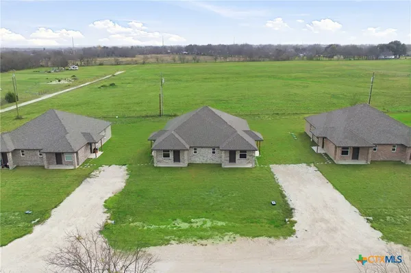 a aerial view of a house with big yard
