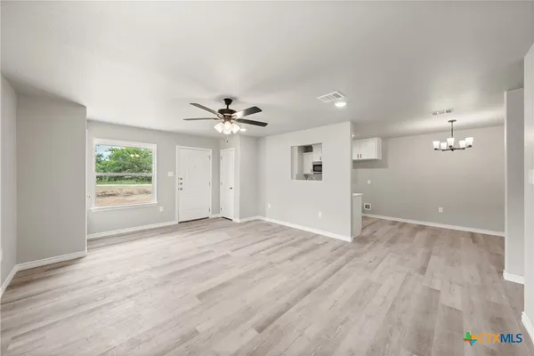 a view of an empty room with a window