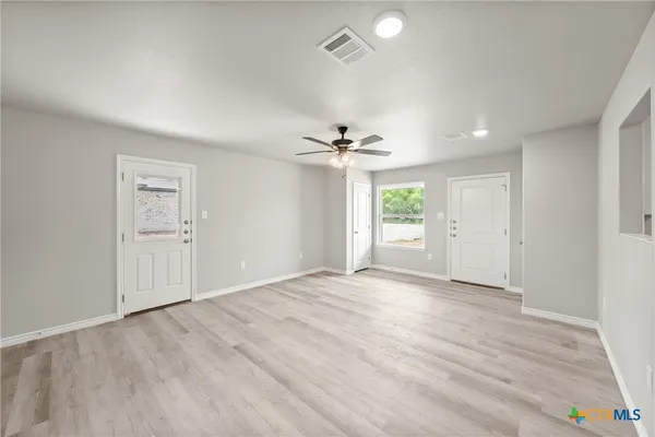 a view of an empty room with a window